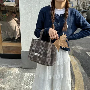 Detailed view of retro plaid wool tote bag for women, cozy autumn winter handbag accessory.