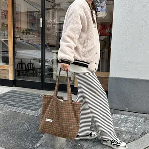 Detail view of the retro plaid wool tote bag, featuring cozy tweed fabric and large capacity design.