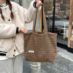 Detail view of the vintage woolen plaid tote bag, large capacity winter shoulder bag for women.