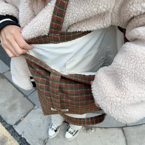Close-up of interior lining and zipper pocket of the vintage plaid wool tote bag detail.