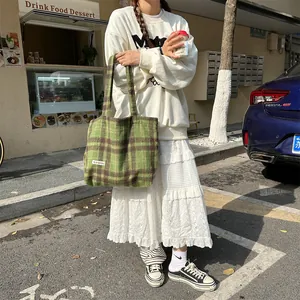Green plaid woolen tote bag detail, retro style large capacity shoulder bag scene display.