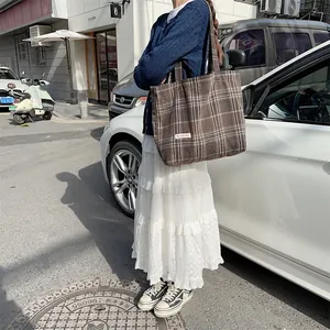 Casual brown woolen plaid tote bag detail shot, large capacity autumn winter shoulder bag.