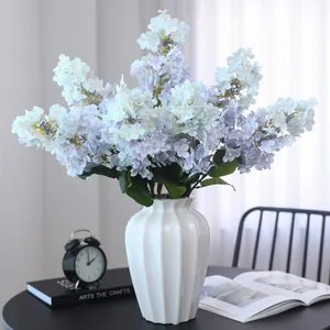 Mazzetto di ortensie artificiali con vaso in ceramica bianca per decorazione casa.