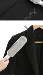 Detail showing a static lint remover brush clearing dust and hair from a black blazer.