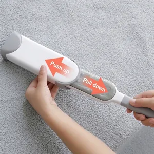 Static lint remover brush for pet hair removal and clothes cleaning on grey fabric background