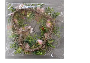 Valentine heart wreath with pink roses and green leaves for romantic wedding decor detail.