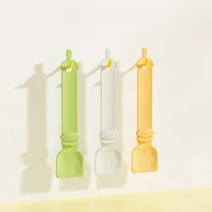 Pet cat strip feeder spoon, plastic treat squeezer and handy press tool for easy pet feeding.