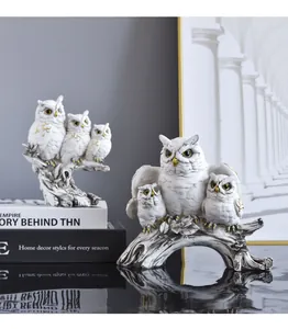 Detailed close-up view of retro resin owl figurines with elegant golden accents