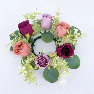 Detailed view of artificial eucalyptus leaf and rose candle ring, perfect floral decor piece.