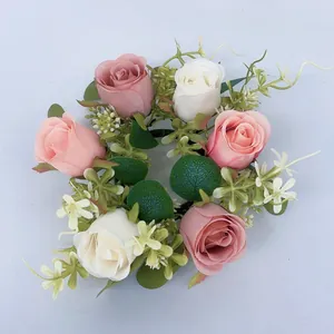 Detail shot of artificial eucalyptus candle ring with pink and white roses, perfect for home decor.