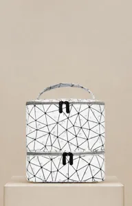 Double-layer waterproof PU cosmetic bag detail showing geometric pattern and smooth zipper.