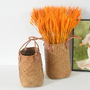 Natural seagrass woven baskets featuring leather patches and rustic rope handles