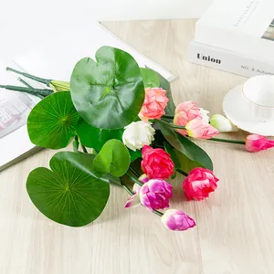 Artificial lotus flowers detail shot, showing vibrant pink and white petals with green leaves for decor.
