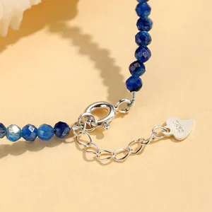 Detail of blue faceted crystal bracelet with S925 silver clasp and heart charm