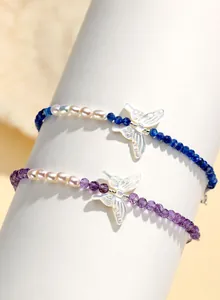 Detail of butterfly freshwater pearl bracelets with amethyst and lapis lazuli beads.