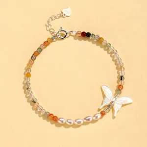 Detailed view of the S925 silver bracelet featuring natural stones and a butterfly.