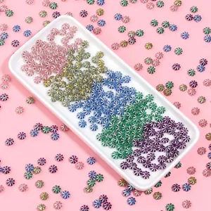 Colorful plastic pumpkin spacer beads with silver-plated edges, ideal for DIY jewelry making.