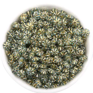 Detail shot of blue-green pumpkin beads with metallic edges, perfect for DIY jewelry making.