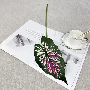 Artificial caladium leaf detail shot, decorative green plant stem for home decor and display.