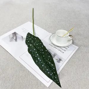 Detailed close-up view of a single artificial alocasia leaf with white spots for home decor.