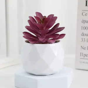 Artificial succulent potted plant with white geometric plastic pot for home decor.