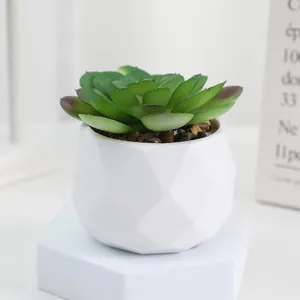 Artificial succulent potted plant in white geometric pot for home and office decoration.