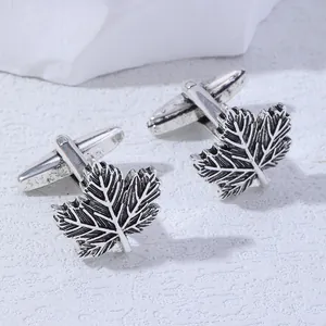 Detail view of vintage silver maple leaf cufflinks, elegant men shirt accessory design.