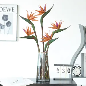 Large artificial Bird of Paradise flower arrangement in glass vase, perfect for living room decor.