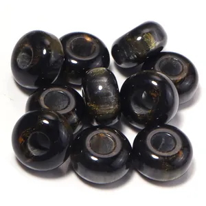 Close-up detail of black and gold resin abacus beads, large hole loose beads for DIY jewelry.
