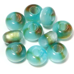 Detailed view of turquoise resin cat eye loose beads with gold foil, perfect for DIY jewelry.