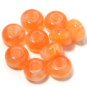 Closeup of orange resin gilt abacus beads, large hole loose beads for DIY phone charm accessories.