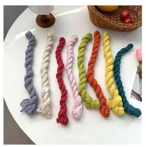 Detailed view of colorful twisted fabric ribbons, candy colors, pleated design for styling.