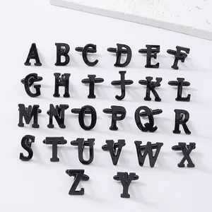 Detailed view of black alphabet letter cufflinks, showing the complete set from A to Z clearly.