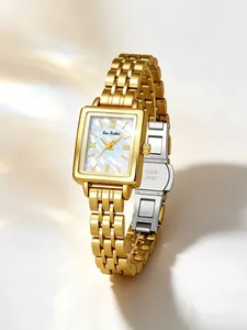 Detailed view of the elegant gold square women's watch and pearl dial texture