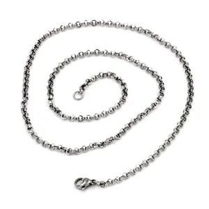 Close-up macro view of a 2mm stainless steel rolo chain necklace with smooth texture