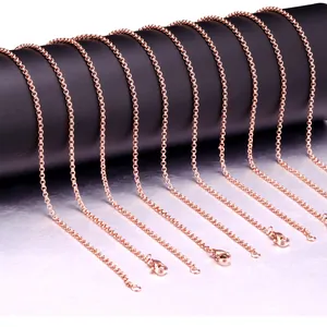Detailed macro view of 2mm rose gold stainless steel O-link chains with lobster clasps