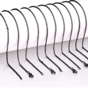 Detail view of 2mm black stainless steel chain necklaces with secure lobster clasps.