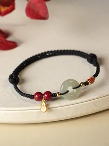 Bracelet artisanal en cordon noir avec pendentif en jade et perles de cinabre doré