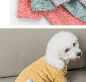 Detail of a white poodle wearing a yellow textured knit sweater for small dogs