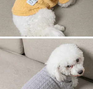 Close-up view showing the detail of yellow and grey cable-knit sweaters for small pet dogs