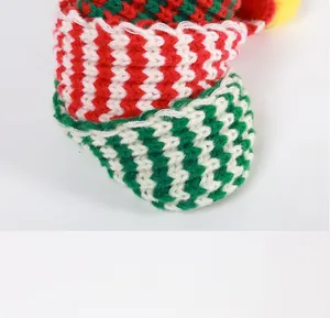Close-up detail of a soft knitted pet scarf featuring red and green zigzag patterns