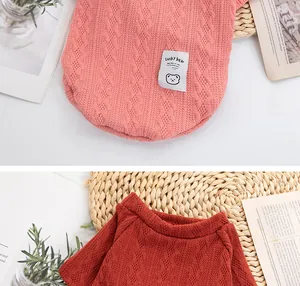 Detailed view of soft cable knit pet sweater featuring cute Lucky Bear patch in pink and red