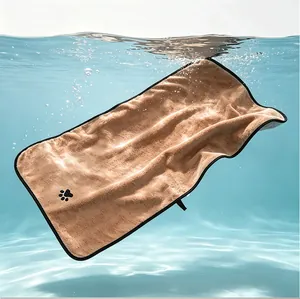 Detail view of a soft brown coral fleece pet bath towel submerged in water