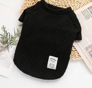Detail of black knitted pet sweater with Lucky Bear patch and diamond pattern