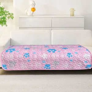 Detailed view of a pink ice silk pet cooling mat with paw print design on a white sofa