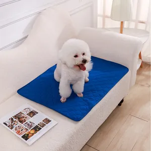 Close-up of a washable blue pet pee mat with absorbent hexagonal texture shown on a white sofa