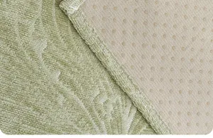 Close-up of non-slip pet mat showing green fabric and anti-slip backing texture