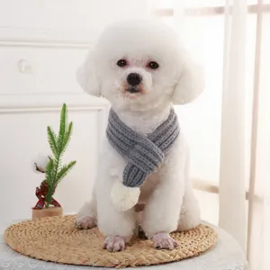 Stylish grey knitted pet scarf with white pom-pom for small dogs in winter season