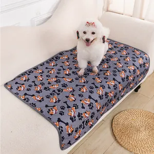 Close-up view of gray pet sofa mat with cute corgi and paw print patterns for dogs and cats.