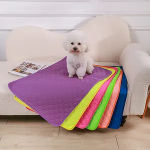 Washable absorbent pet pee pads for dogs in multiple colors on a white sofa